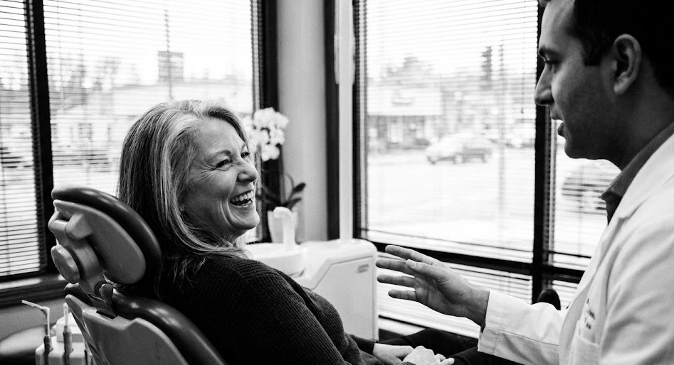 Patient smiling during consultation with dentist at a modern dental clinic